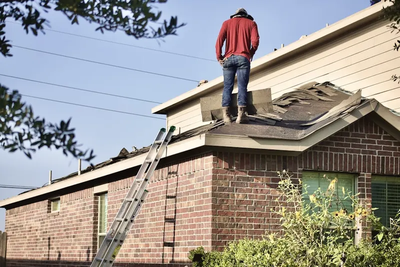 Professional roofer working on a residential roof in Brookhurst